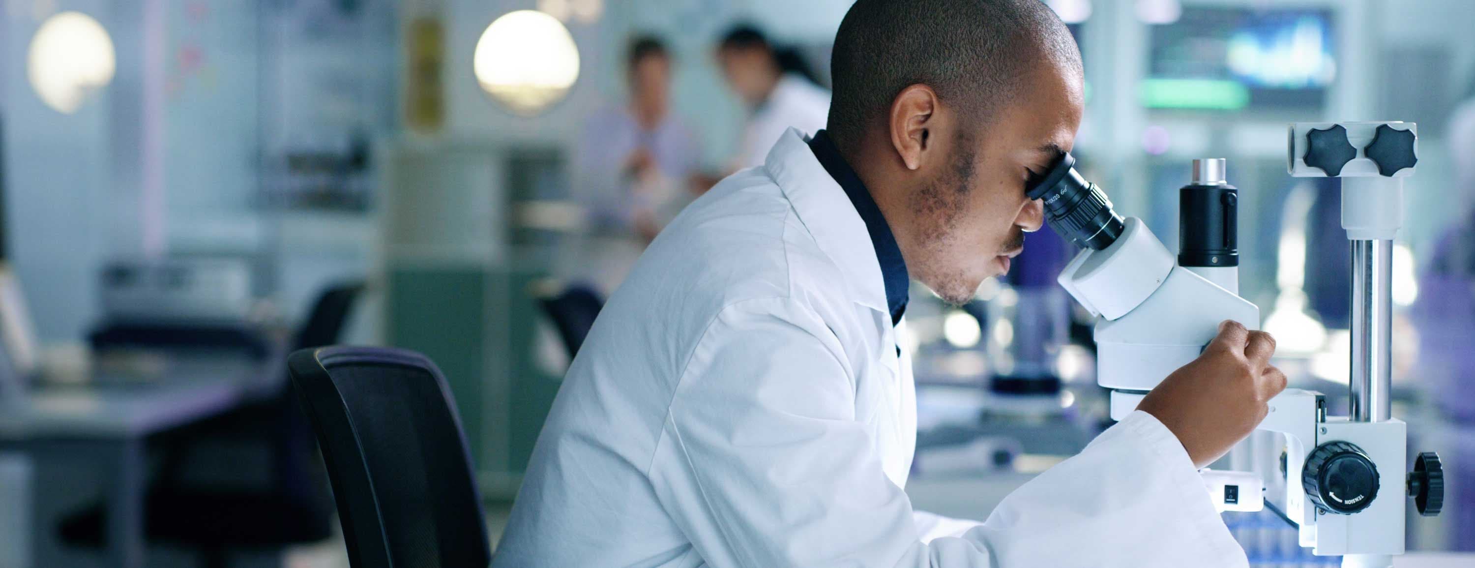 Scientist looking in microscope